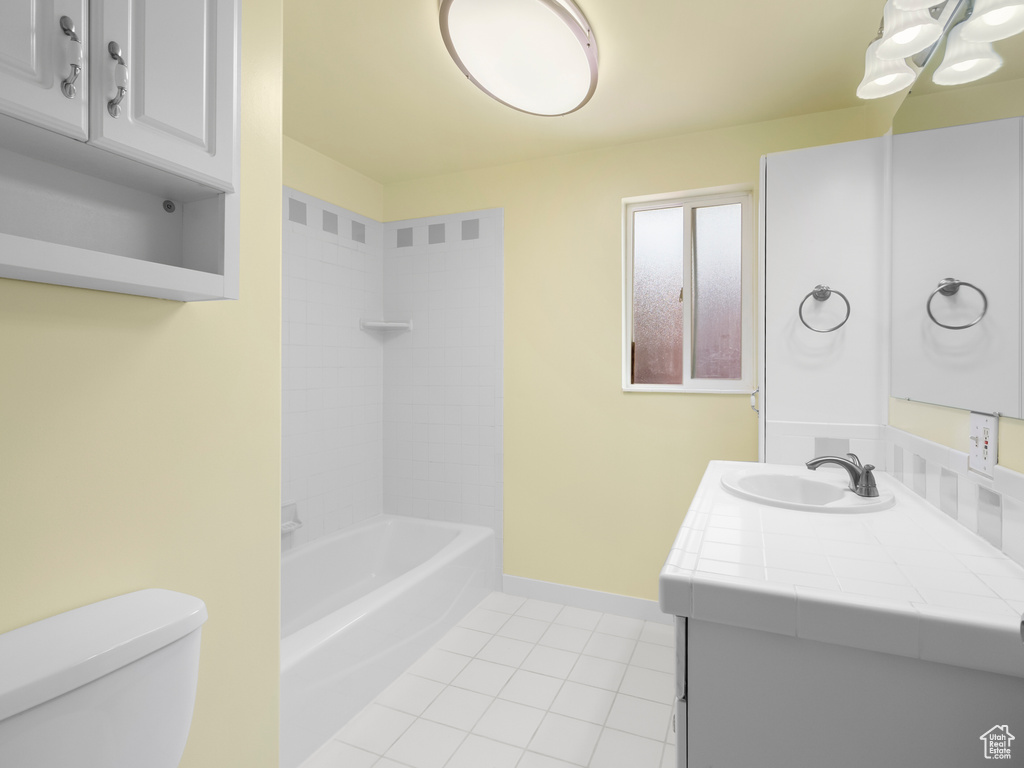 Full bathroom featuring tile patterned flooring, vanity, and shower / bathtub combination