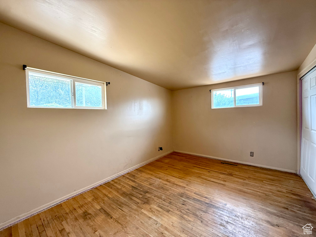 Empty room featuring light wood finished floors and baseboards