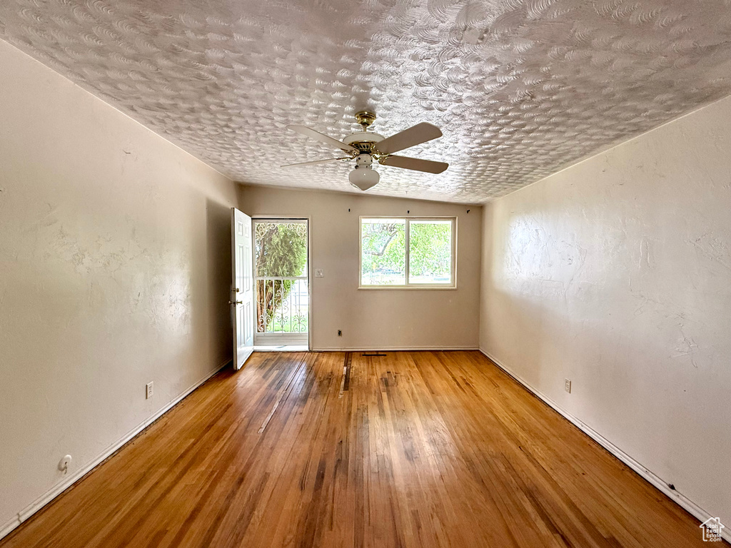 Unfurnished room featuring a ceiling fan and hardwood / wood-style flooring