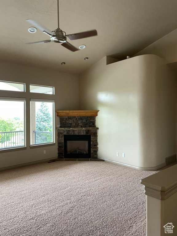 Unfurnished living room featuring carpet, a ceiling fan, a fireplace, and recessed lighting