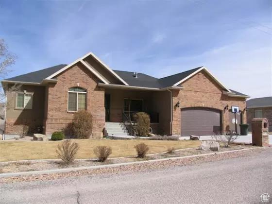 Ranch-style house featuring a garage and brick siding