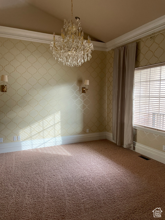 Spare room featuring lofted ceiling, a chandelier, and carpet floors