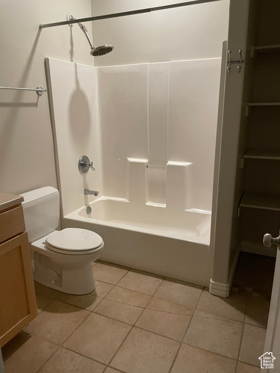 Full bath featuring washtub / shower combination, tile patterned flooring, and vanity