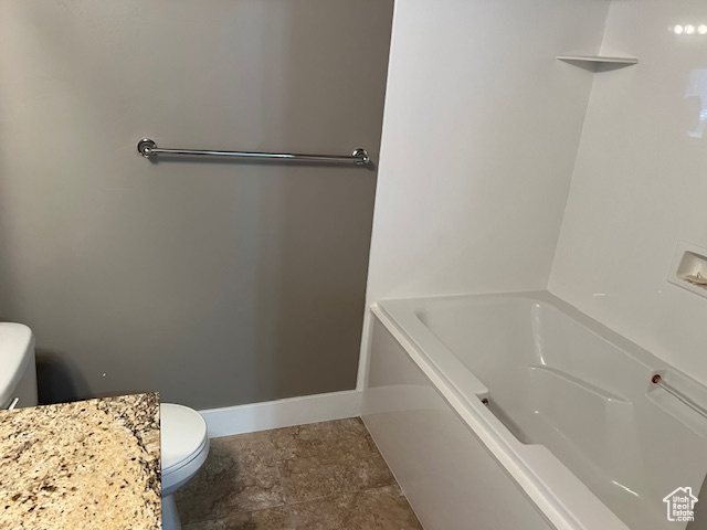 Full bath with toilet and a tub to relax in