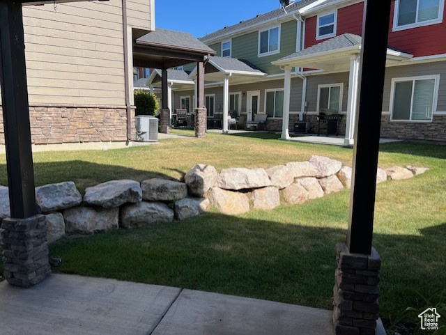 View of grassy yard with a patio