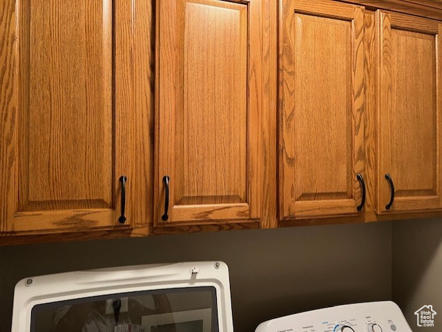 Laundry area with cabinet space and washer / clothes dryer