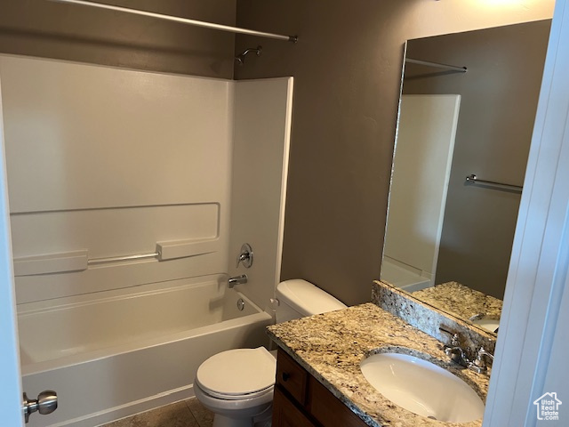 Full bathroom featuring shower / tub combination, vanity, and tile patterned flooring