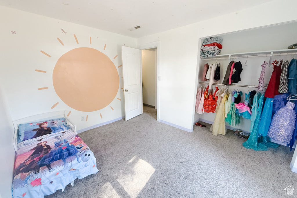 Bedroom featuring carpet floors and a closet