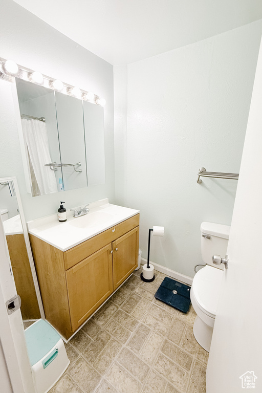 Full bathroom featuring toilet and vanity