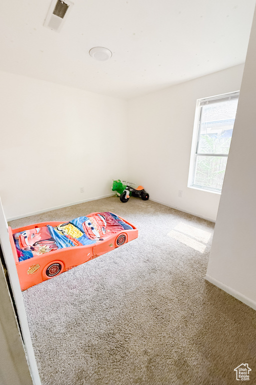 Rec room with carpet and baseboards