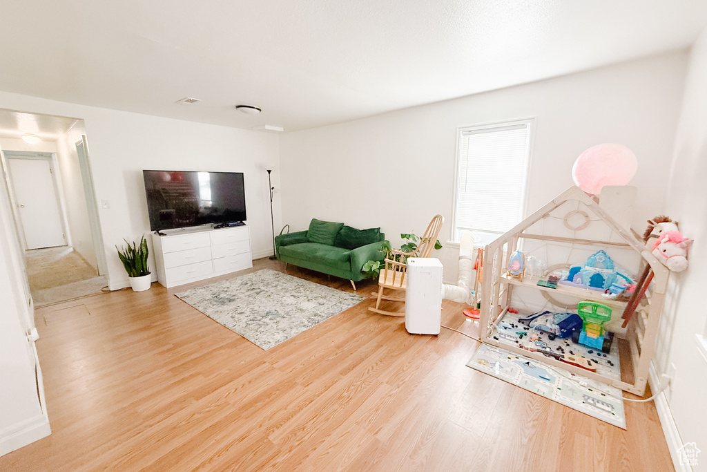 Living area with wood finished floors and baseboards