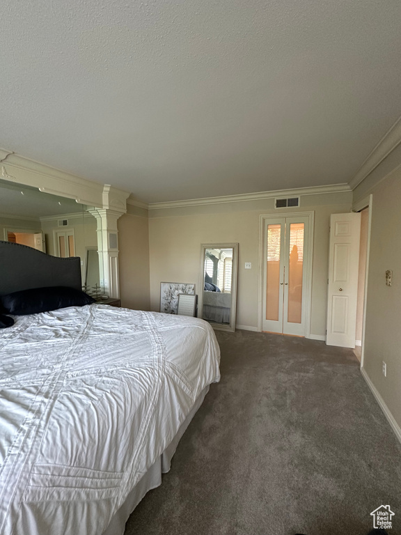 Bedroom featuring crown molding, carpet, french doors, and a textured ceiling