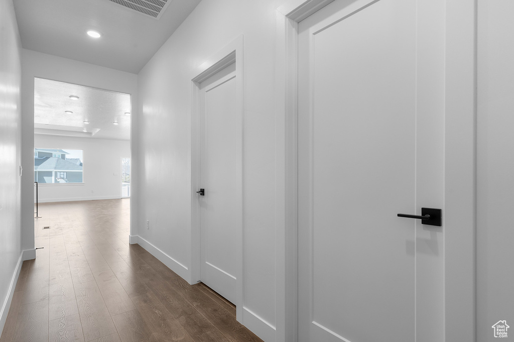 Hallway featuring dark wood-style floors and recessed lighting