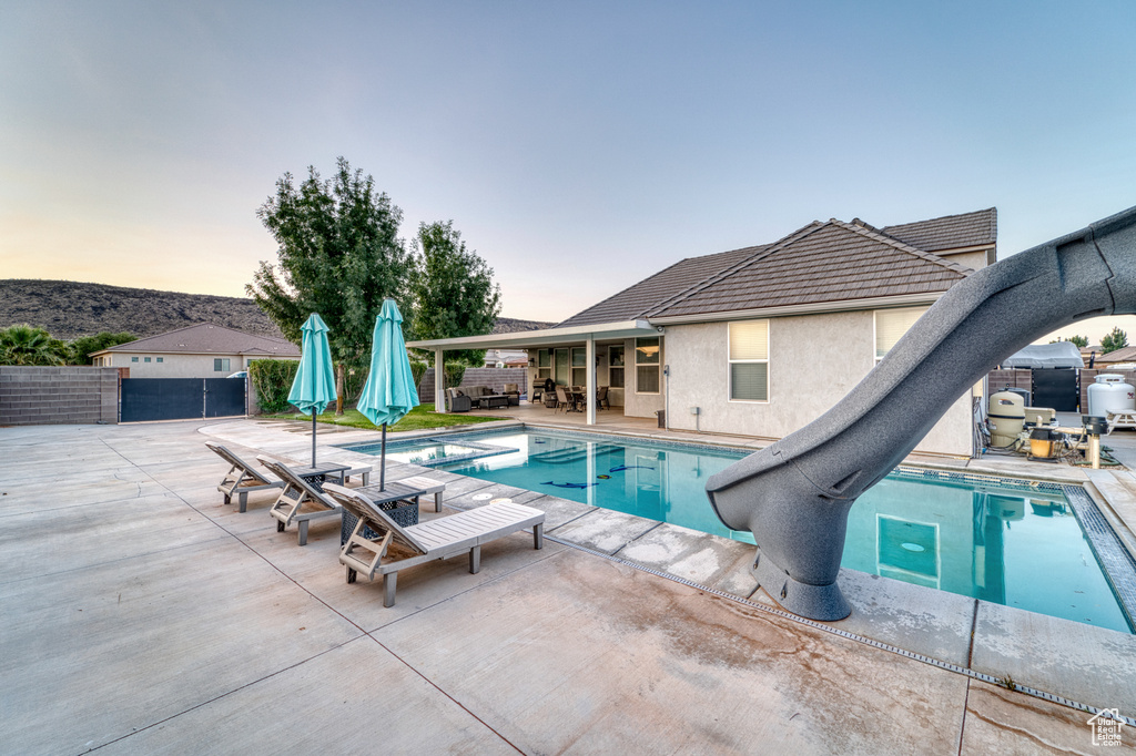 View of swimming pool featuring a patio area and a fenced backyard