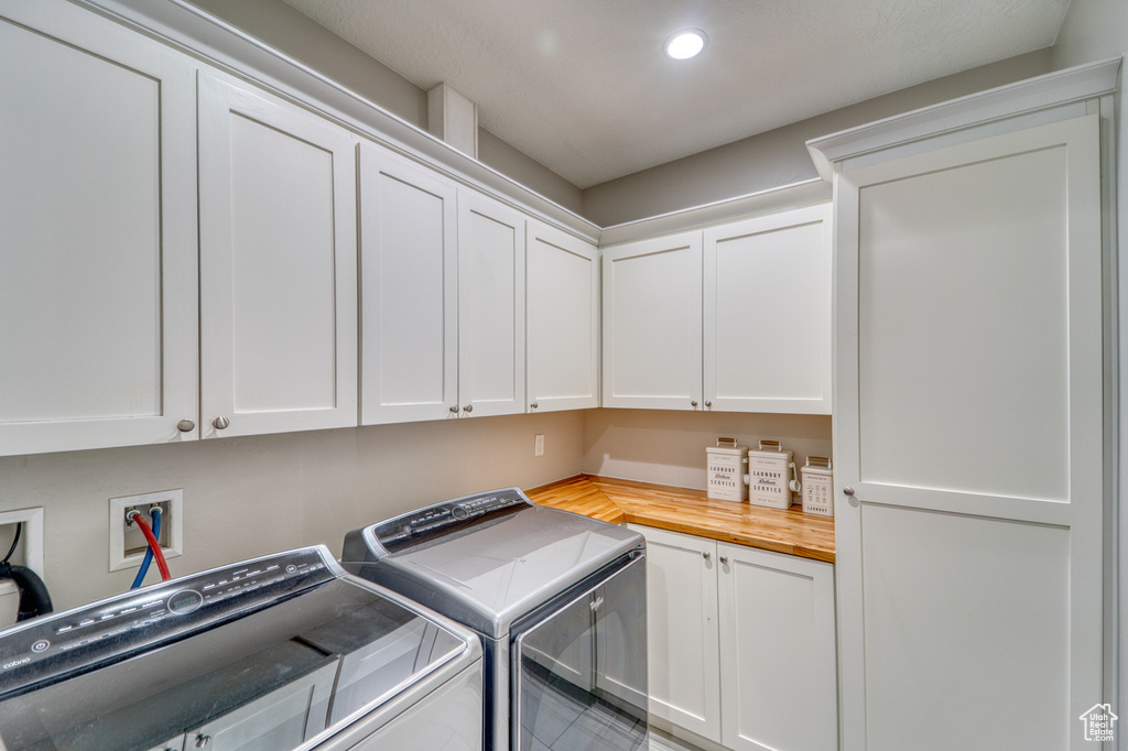 Laundry room with cabinet space, washing machine and clothes dryer, and recessed lighting