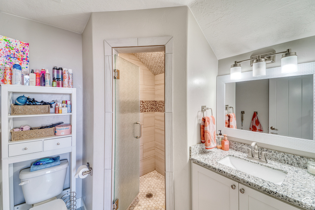 Bathroom featuring a stall shower and vanity