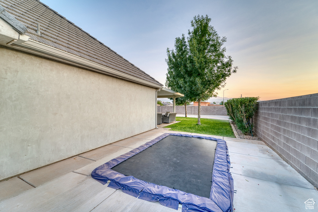 View of swimming pool with a fenced backyard and a patio