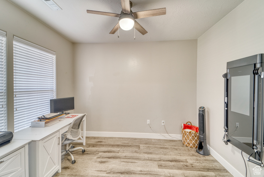 Office space featuring light wood-type flooring and ceiling fan