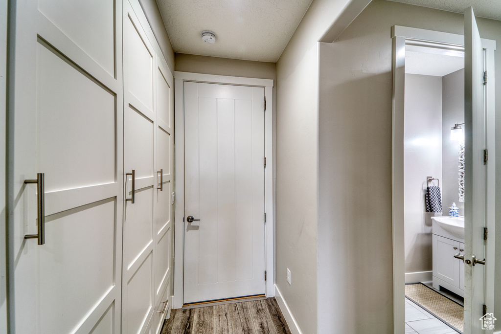 Doorway with baseboards and light wood finished floors