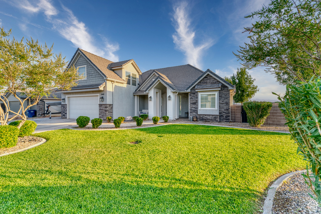 Craftsman house featuring stone siding, concrete driveway, stucco siding, and an attached garage