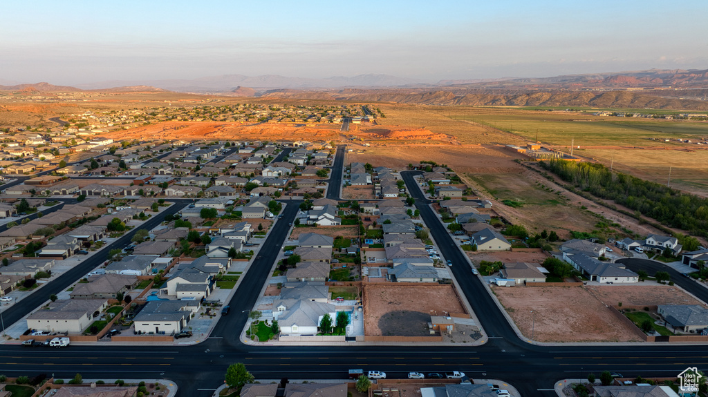 Aerial overview of property\\\\\\\'s location with a mountainous background and nearby suburban area