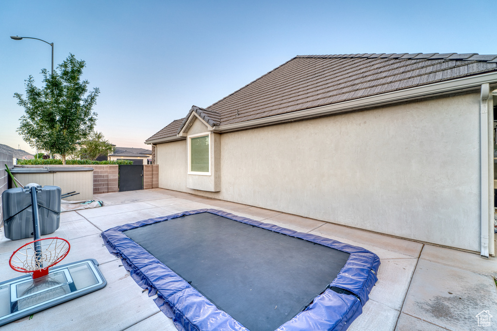 Pool at dusk featuring a patio area