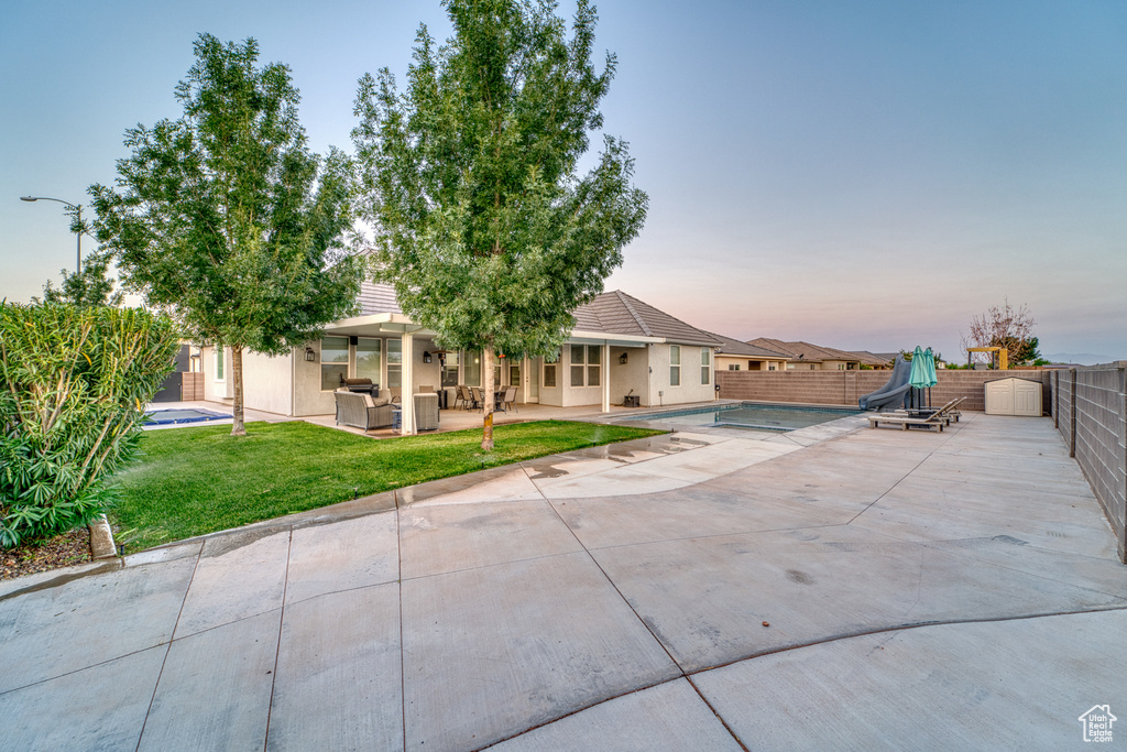 Back of property with a patio area, stucco siding, and an outdoor hangout area