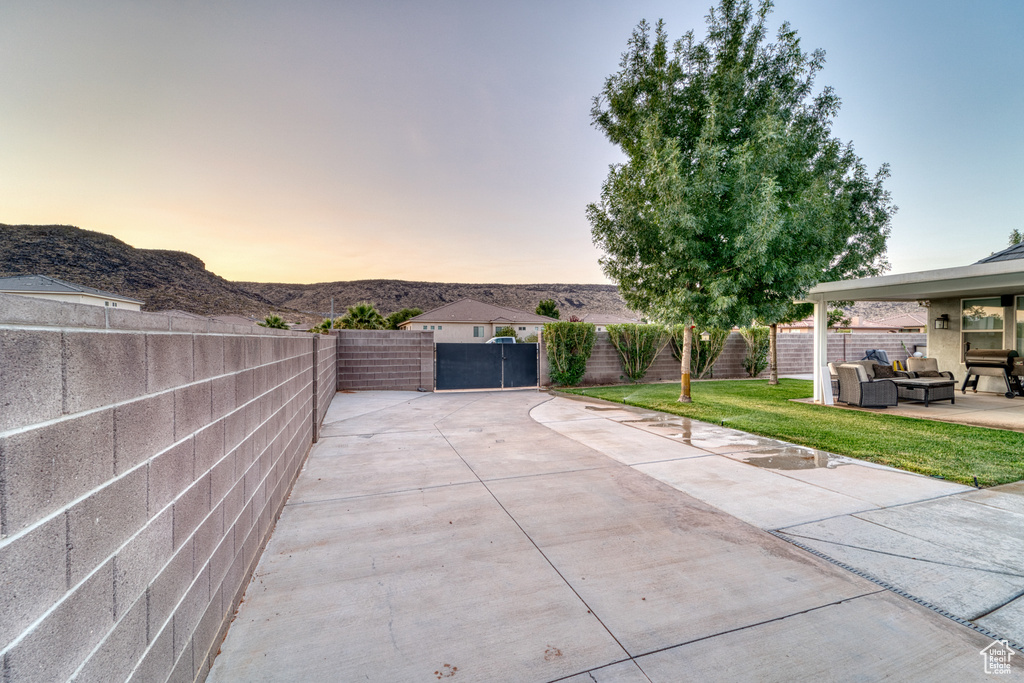 Fenced backyard with outdoor lounge area, a patio area, and a mountain view