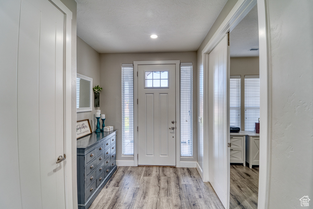 Entryway featuring light wood-type flooring and baseboards