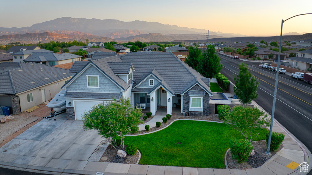 View of front of house with stone siding, a mountain view, and a residential view