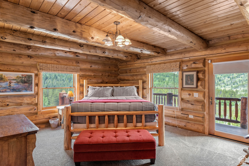 Carpeted bedroom featuring a wooden ceiling with exposed beams, multiple windows, rustic walls, a chandelier, and access to outside
