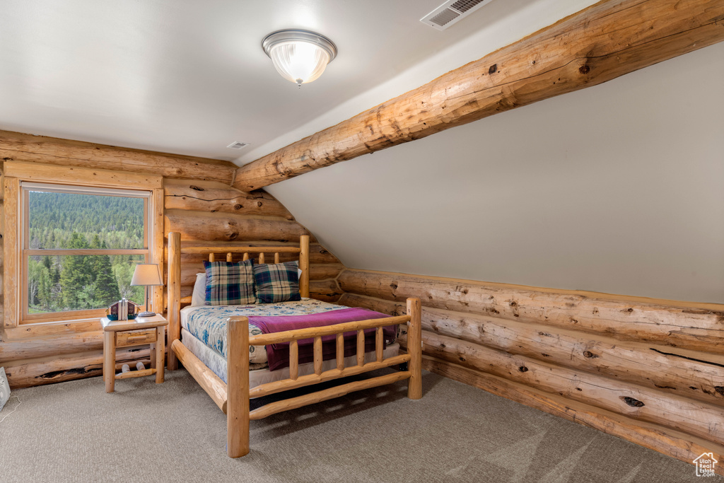 Bedroom with rustic walls and carpet