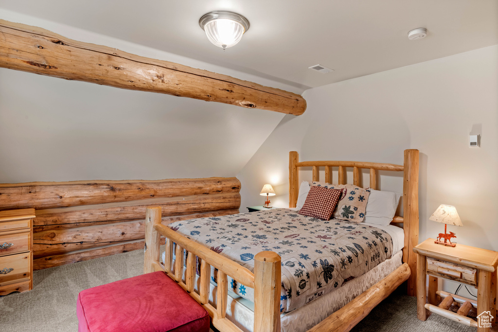 Carpeted bedroom with rustic walls