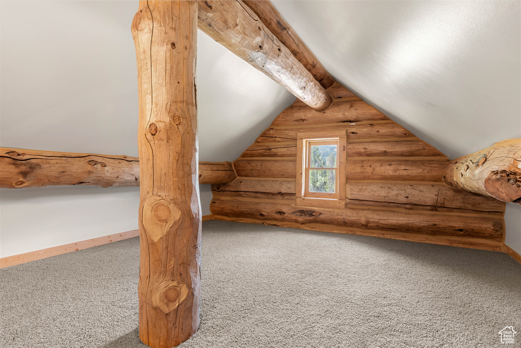 Bonus room with log walls and carpet floors