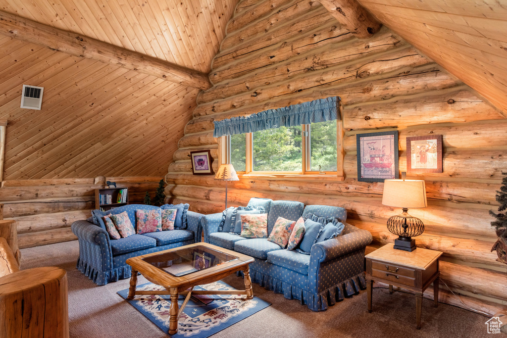 Living room with log walls, carpet floors, and wood ceiling