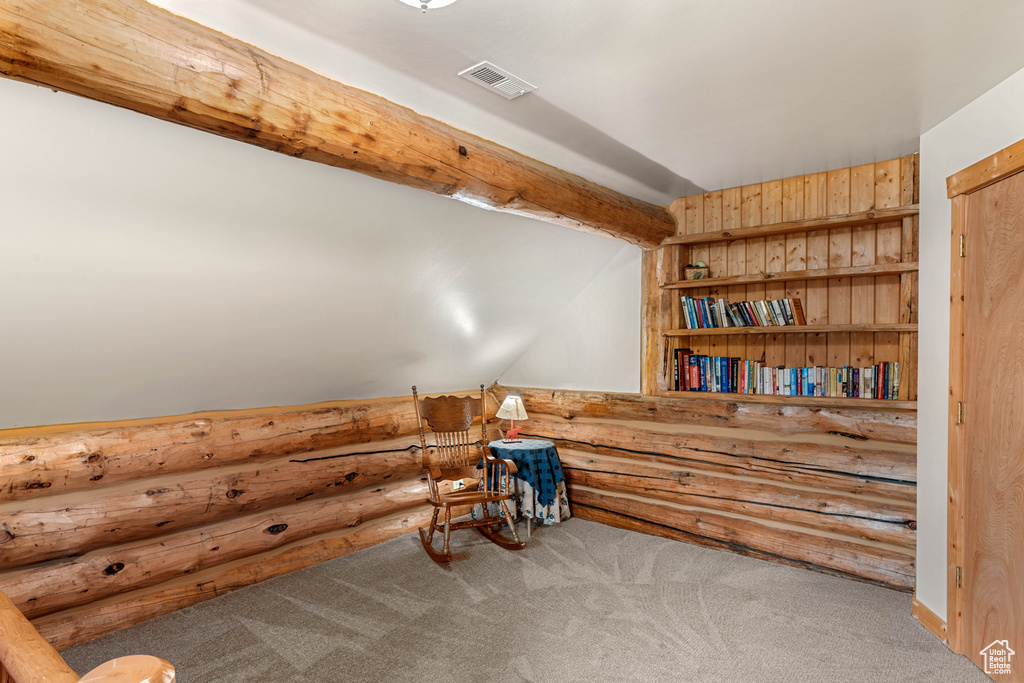 Sitting room with carpet and log walls