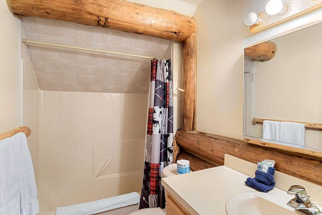 Bathroom with vanity and curtained shower