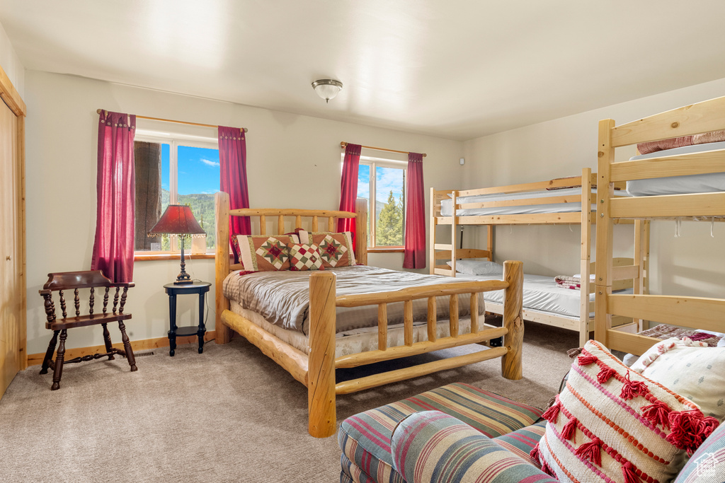 Carpeted bedroom featuring baseboards