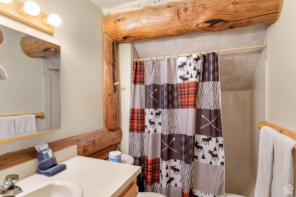 Full bathroom featuring toilet and vanity