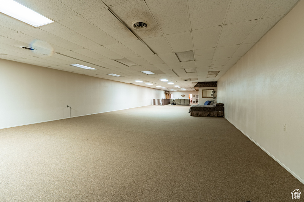 Basement featuring carpet floors and a paneled ceiling