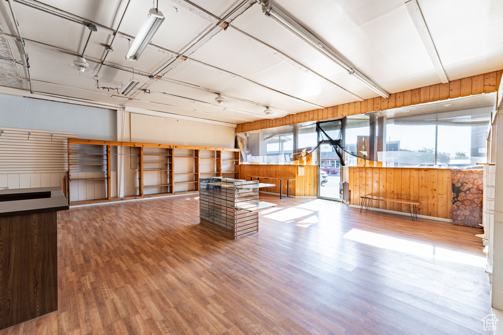 Misc room featuring healthy amount of natural light, wood finished floors, and wood walls