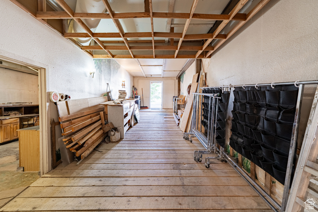 Hall featuring a textured wall and light wood-style floors