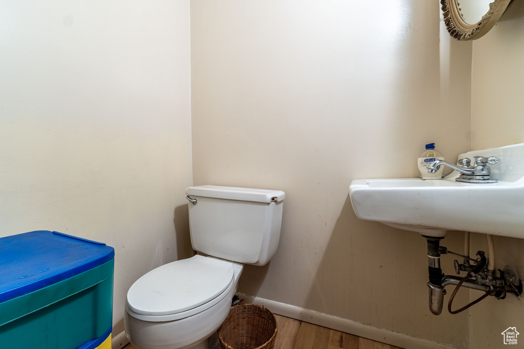 Bathroom featuring wood finished floors and toilet