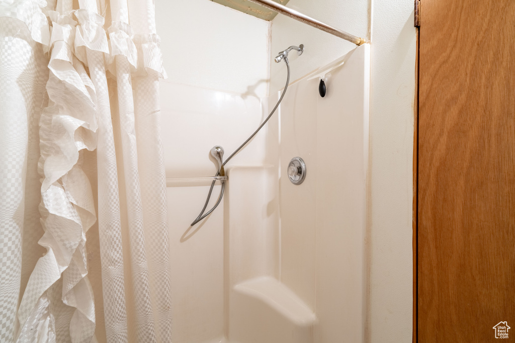 Bathroom view of a shower with shower curtain