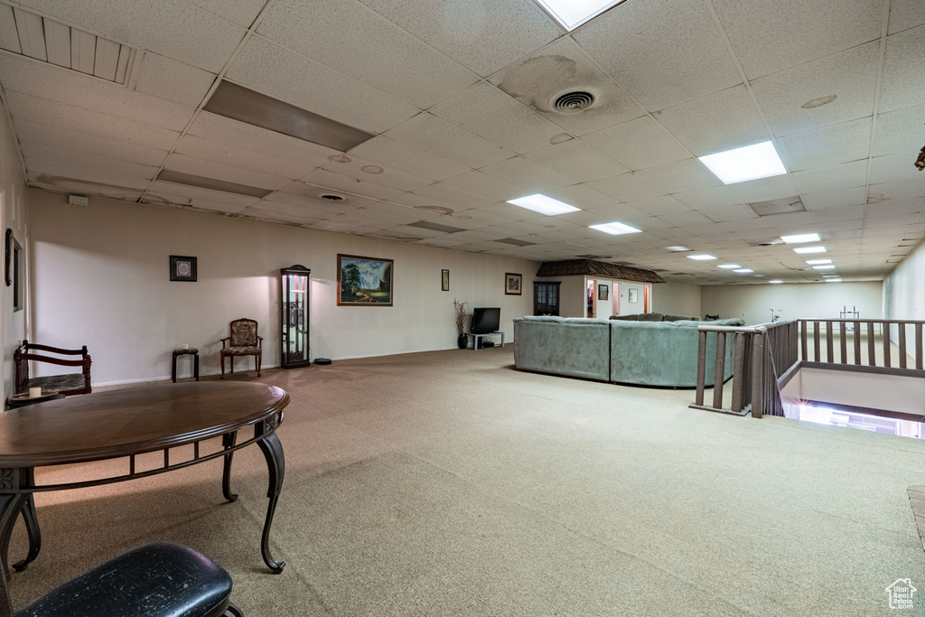 Living area with carpet floors and a drop ceiling