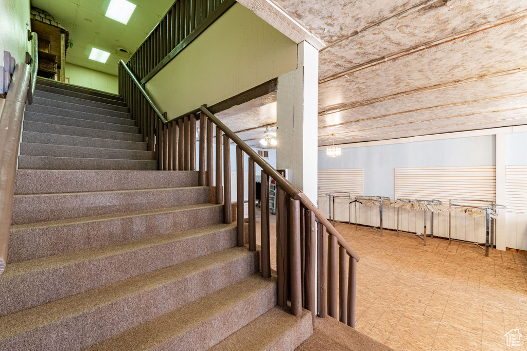 Stairway featuring tile patterned floors