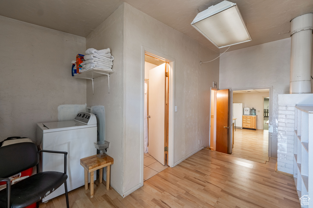 Laundry room with washer / clothes dryer and light wood finished floors