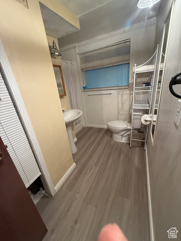 Bathroom featuring toilet and wood finished floors