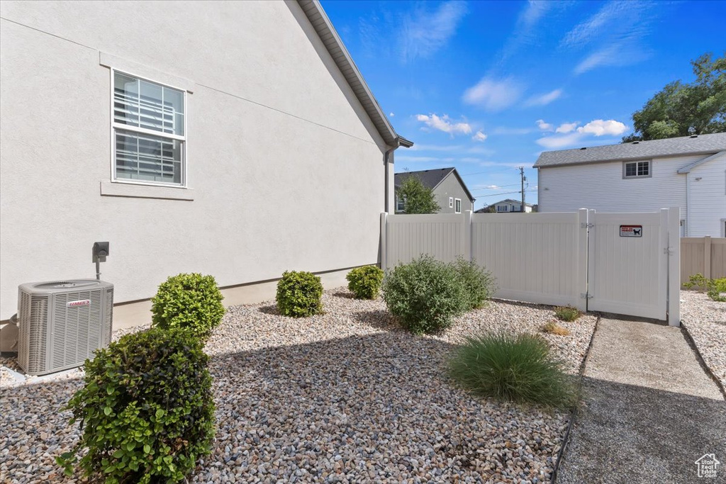 View of property exterior with a gate and stucco siding