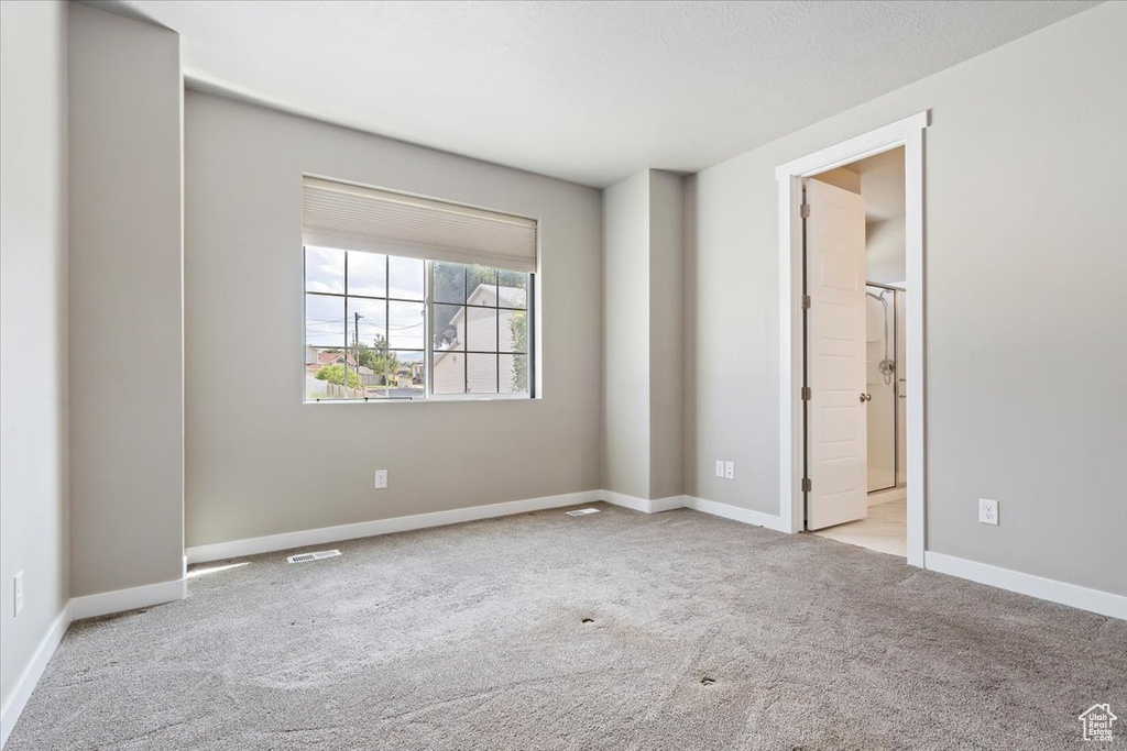 Unfurnished bedroom featuring carpet floors and baseboards